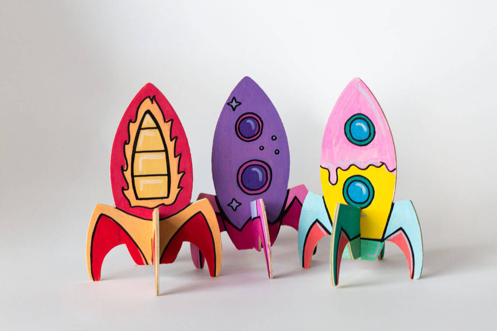 Bunte Holzraketen bemalen auf weißem Hintergrund 
